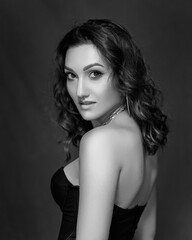 Naklejka premium black and white portrait. Sexy girl in a black corset and gloves