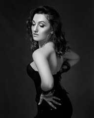 Naklejka premium black and white portrait. Sexy girl in a black corset and gloves