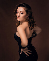 Fototapeta premium Sexy girl in a black corset and gloves