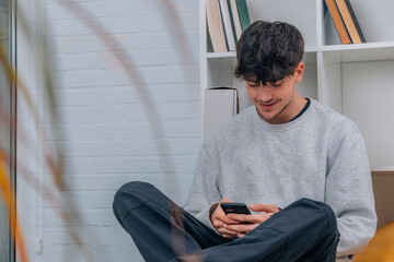 young man at home with mobile phone