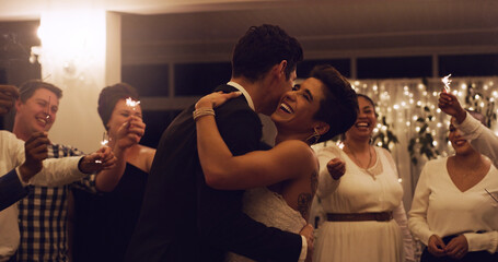 Love was meant to be synonymous with happiness. Cropped shot of an affectionate young newlywed couple dancing while their guests are holding up sparklers at their wedding reception. - Powered by Adobe