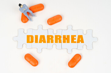 On the white surface of the tablet, a miniature human figure and puzzles with the inscription - DIARRHEA