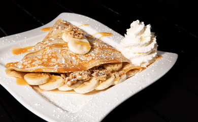 Banana Crepe with Carmel and nuts with side of whip cream 