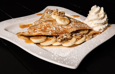 Banana Crepe with Carmel and nuts with side of whip cream 