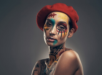 Beauty begins the moment you decide to be yourself. Studio shot of a young woman posing with paint...