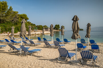 Beautiful beach with umbrellas and sunbeds in Ksamil, Albania