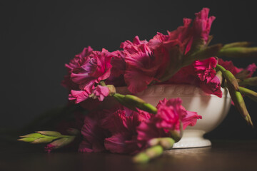 Arrangement of pink flowers in bowl on table with copy space