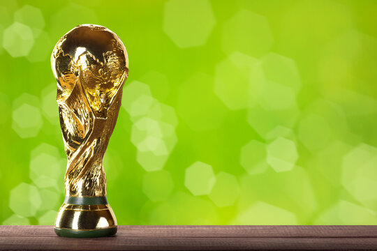Moscow, Russia - April, 2022: FIFA World Cup Trophy against green background.