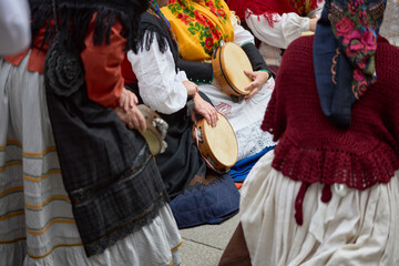 Women in period costumes playing tambourines at a popular festival in the city of Vigo, Galicia, Spain.