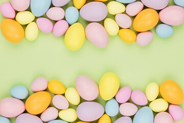 Fototapeta na wymiar Stylish background with colorful easter eggs isolated on pastel green background with copy space. Flat lay, top view, mockup, overhead, template