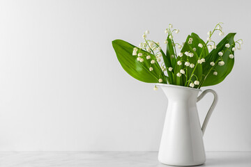 Lily of the valley flowers bouquet in vase on white background. womans day or wedding background