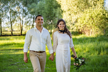 Beautiful bride and groom with sparklers on a meadow.