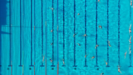 Aerial drone top view photo of swimming pool with athletes practising water polo