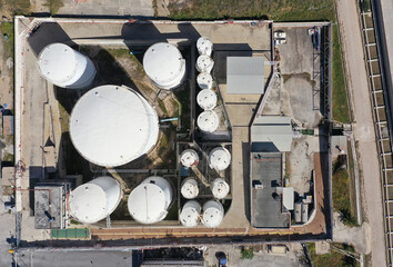 Aerial drone photo of huge crude oil tanks near oil refinery plant