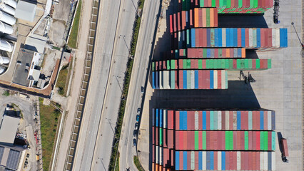 Aerial drone top down photo of colourful containers parked in Mediterranean container terminal