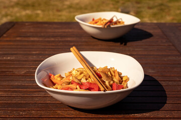 Lo mein stir fry vegetable udon noodles plate, outdoor lunch