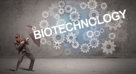 Fototapeta premium Businessman defending with umbrella concept