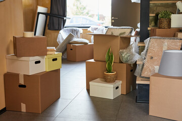 Background image of hallway in new home filled with cardboard boxes, family moving and relocation concept, copy space