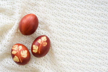 Top view of easter eggs, lying on lace tablecloth. Traditional and rustic arrangement. Easter concept.