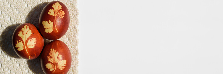 Panoramic photo. Top view of easter eggs, lying on lace tablecloth. Tradition and rustic arrangement. Easter concept.