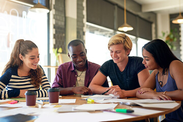 Getting ready to ace that test. Shot of a group of young friends having a study session in a cafe.