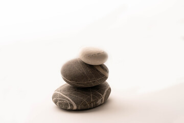 A stack of stones on a white isolated background .Balance and harmony. Copy space.Horizontal photo. Spa and healthcare concept.