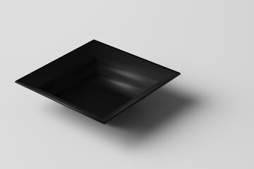 Square black plate is not a white background. Stone plate in the shape of a square. Side view.