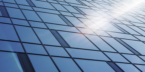 bright sun shines on large corporate building wall with panoramic windows reflecting blue skyscape on summer day