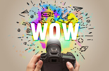 Close-up of a hand holding digital camera with abstract drawing