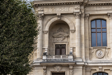 Fototapeta na wymiar Architectural details of old Paris buildings: “Grand Gallery of the Evolution” - imposing Renaissance-revival building, built in 1889. Paris. France.