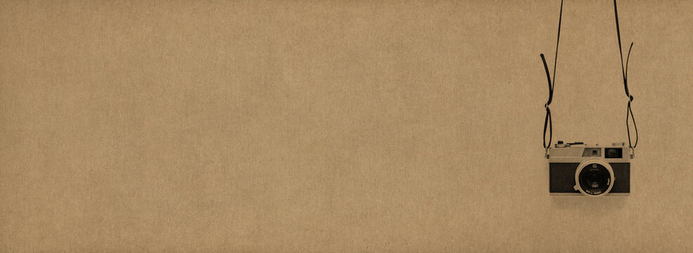 Old Hanging Camera Stamp Over A Natural Home Made Light Brown Paper Background
