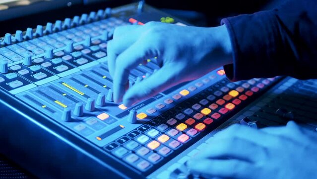 A person is operating a mixing console