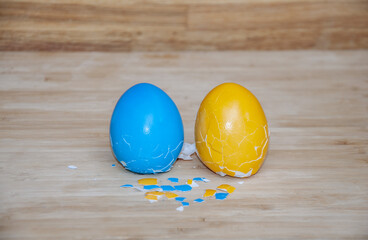 Ukrainian colored blue and yellow easter broken eggs with background