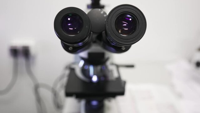 Close-up of a microscope in the laboratory. View through a magnifying glass