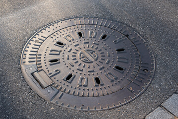 the iron cover of a manhole in a street