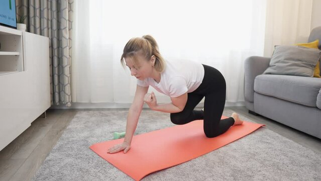 young woman doing fitness at home.