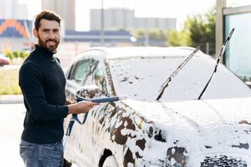 Caucasian man holding special equipment and smiling to the camera