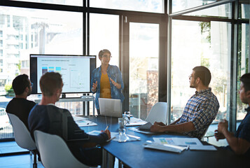 Well get there if we work together. Cropped shot of a young businesswoman giving a presentation in the boardroom.