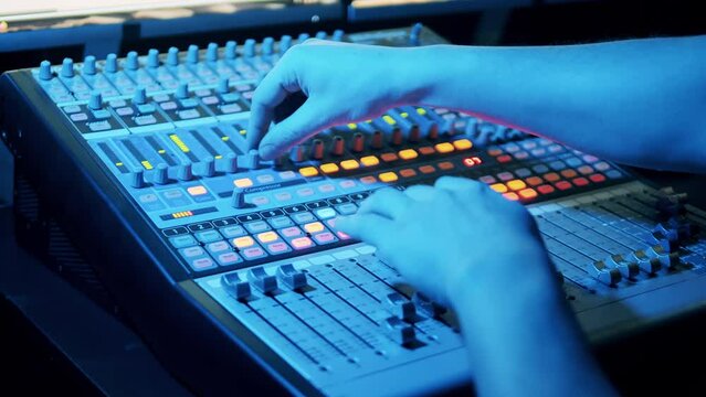 Mixing console is being operated in a recording studio