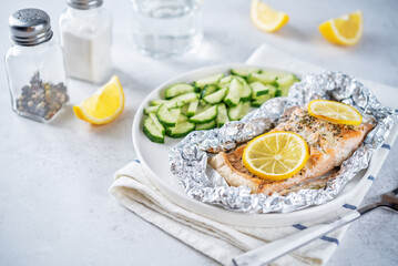Salmon with herbs and lemon slices baked in a foil
