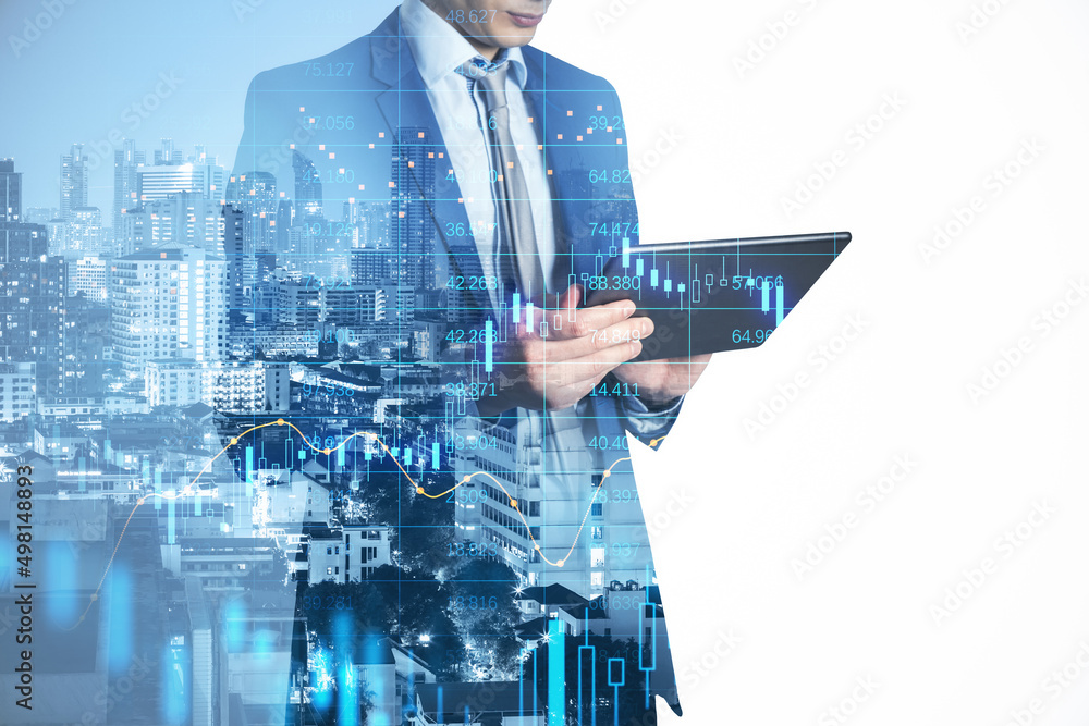 Poster attractive young european businessman using tablet while standing on abstract blue city background w