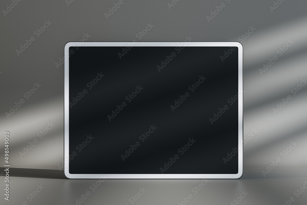 Poster Close up of empty black mock up screen pad on gray wall background with sunlight. Product device presentation concept. 3D Rendering.