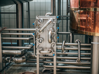 System of steel pipes in food and drink processing plant. Pipelines in brewery factory.
