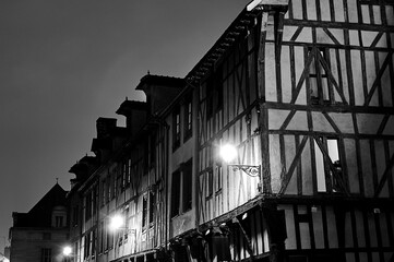 facades of tenement houses in night in old town of Troyes