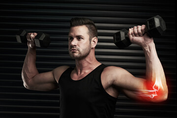 Fototapeta na wymiar Raising his fitness levels. Studio shot of an athletic young man working out with dumbbells.