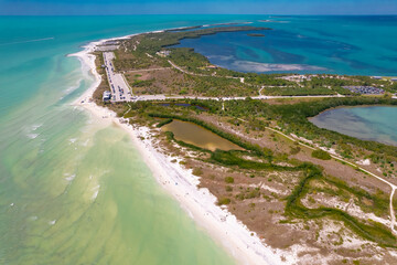 Island. Florida beach. Panorama of Honeymoon Island State Park. Spring or Summer vacations in USA. Blue-turquoise color of salt water. Ocean or Gulf of Mexico. Tropical Nature. Aerial view. High photo