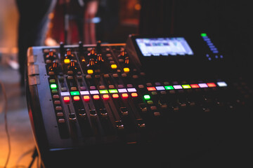View of lighting technician operator working on mixing console workplace during live event concert...