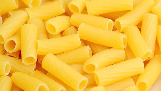 Dry uncooked Italian macaroni rotating close up. High quality 4K footage