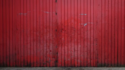 dirty red metal door from industrial building