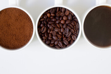 Top view close-up coffees brewed, ground and roasted coffee mugs together